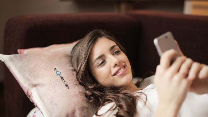 A woman reads a mobile website with quality website accessibility