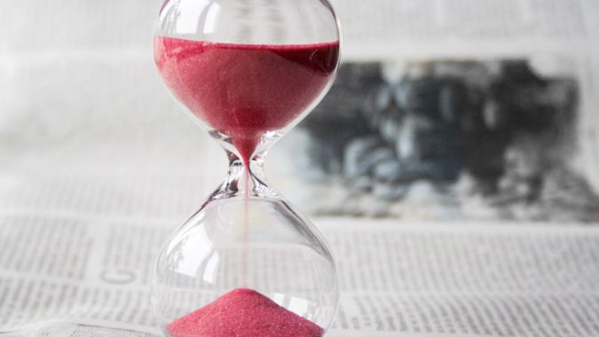 An hourglass with two thirds of its time remaining