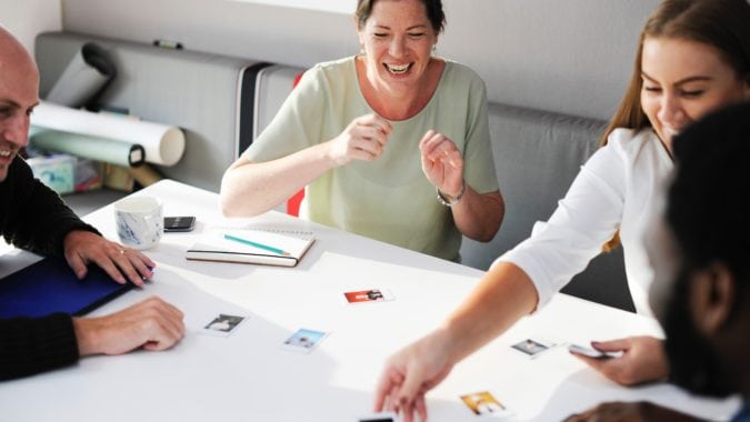 A group of coworkers playing a card game during break time