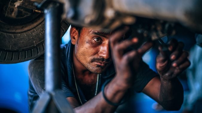 Auto mechanic performing routine maintenance