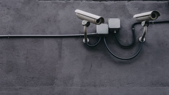 Security cameras on a wall pointing down