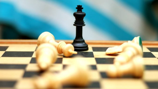 Chess pieces are down and only the King survives